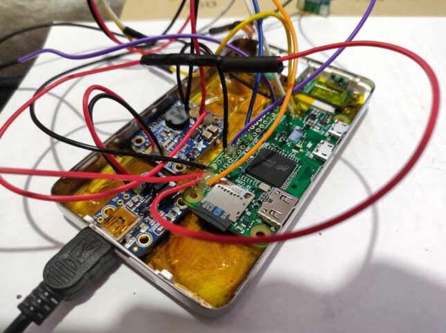 adding hot glue to the soldered connections for the SpotiPod